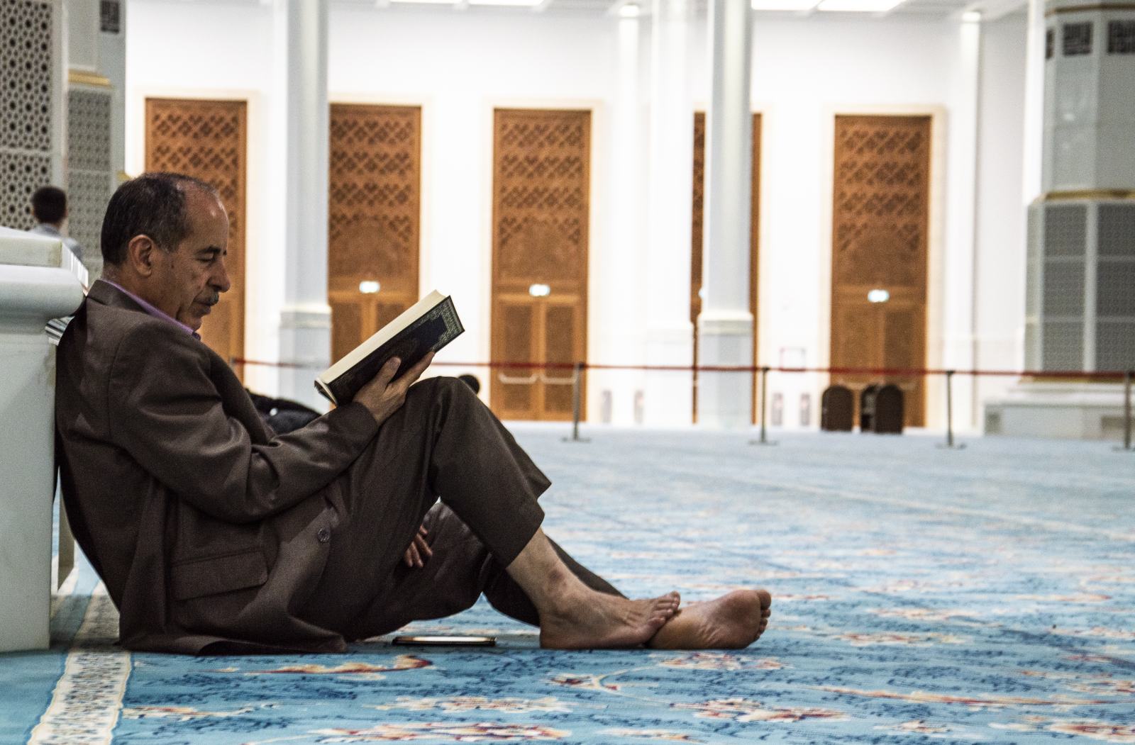 Reading, back against a pillar